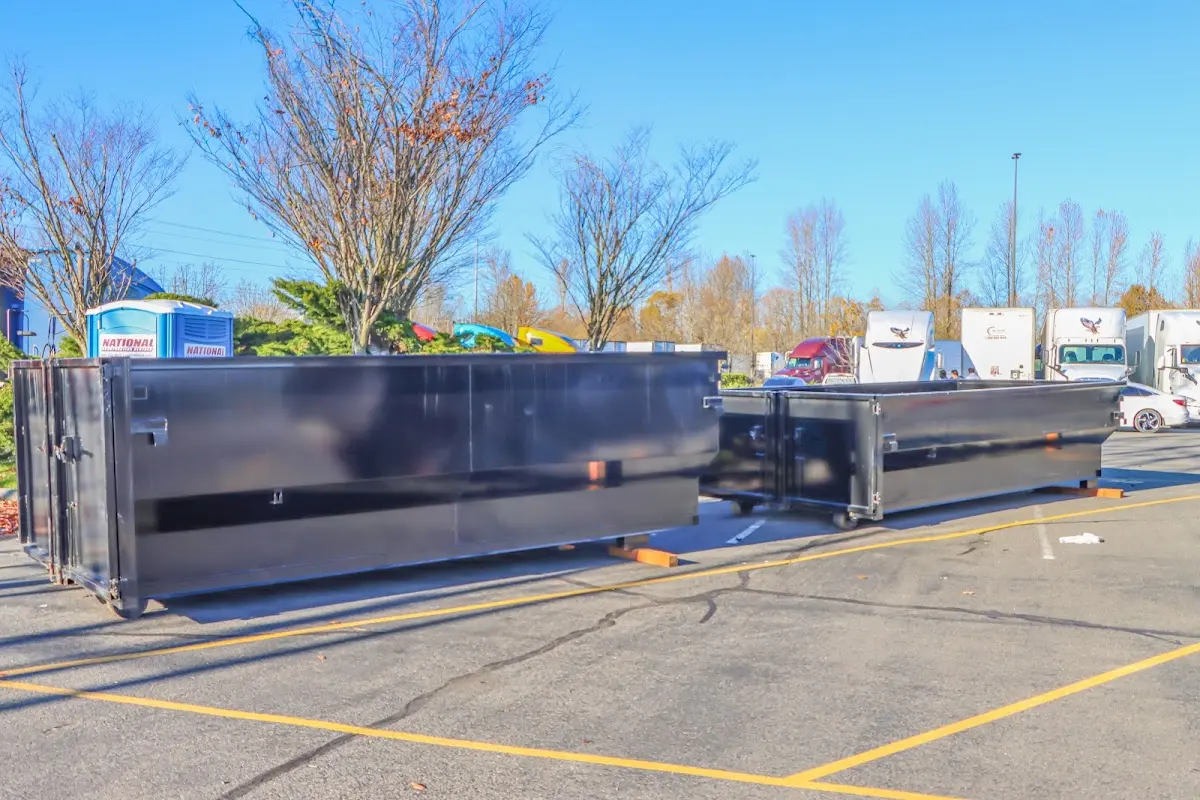 Professional dumpster rental service with roll-off container on residential driveway in Bettendorf